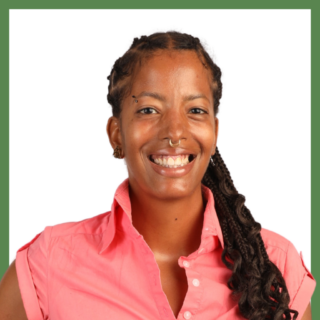 Smiling person with braided hair and a nose ring, wearing a pink button-up shirt, against a white background framed with a green border.