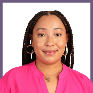 A woman with braided hair smiles at the camera, wearing a bright pink shirt, hoop earrings, and a gold necklace. She stands against a white background with a purple frame.