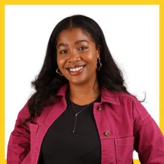 A person with long dark hair smiles while wearing a magenta jacket over a black top. They have hoop earrings and a delicate necklace. The background is white with a yellow border.