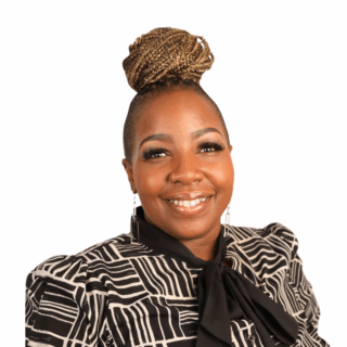 A woman smiling with a bun.