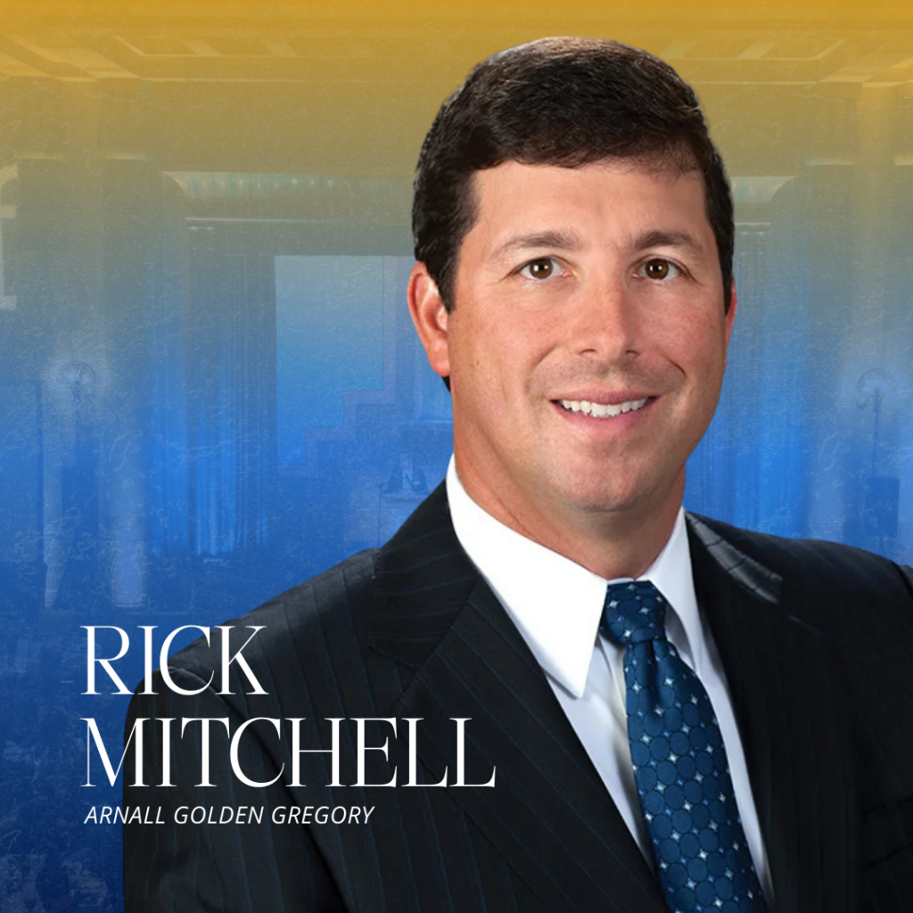 A man in a dark suit, white shirt, and blue polka dot tie smiles at the camera. The background is a gradient of gold and blue with faint architectural details. Text reads: "Rick Mitchell, Arnall Golden Gregory.