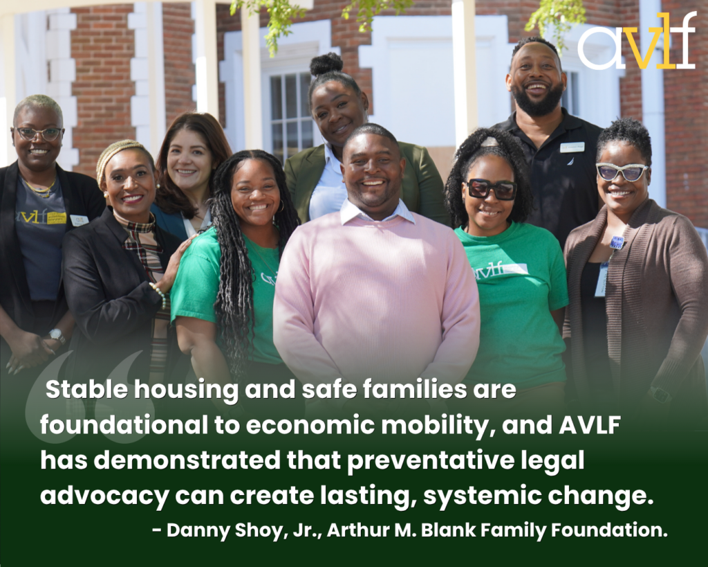 A diverse group of smiling people pose together outdoors in front of a brick building. The image includes a quote about AVLF’s impact on housing and legal advocacy from Danny Shoy, Jr., Arthur M. Blank Family Foundation